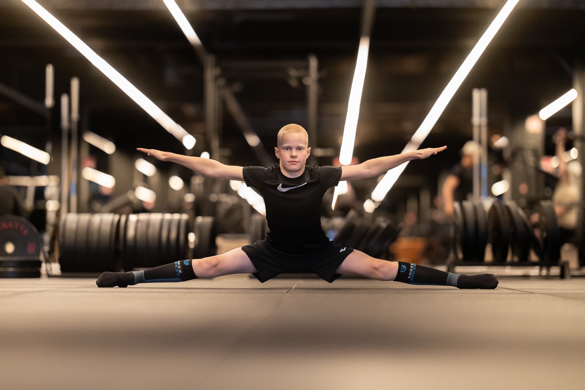 Athlete demonstrating a full split with both arms extended